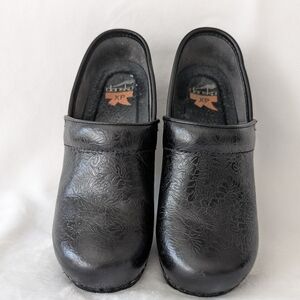 Dansko Black Embossed Floral Clogs